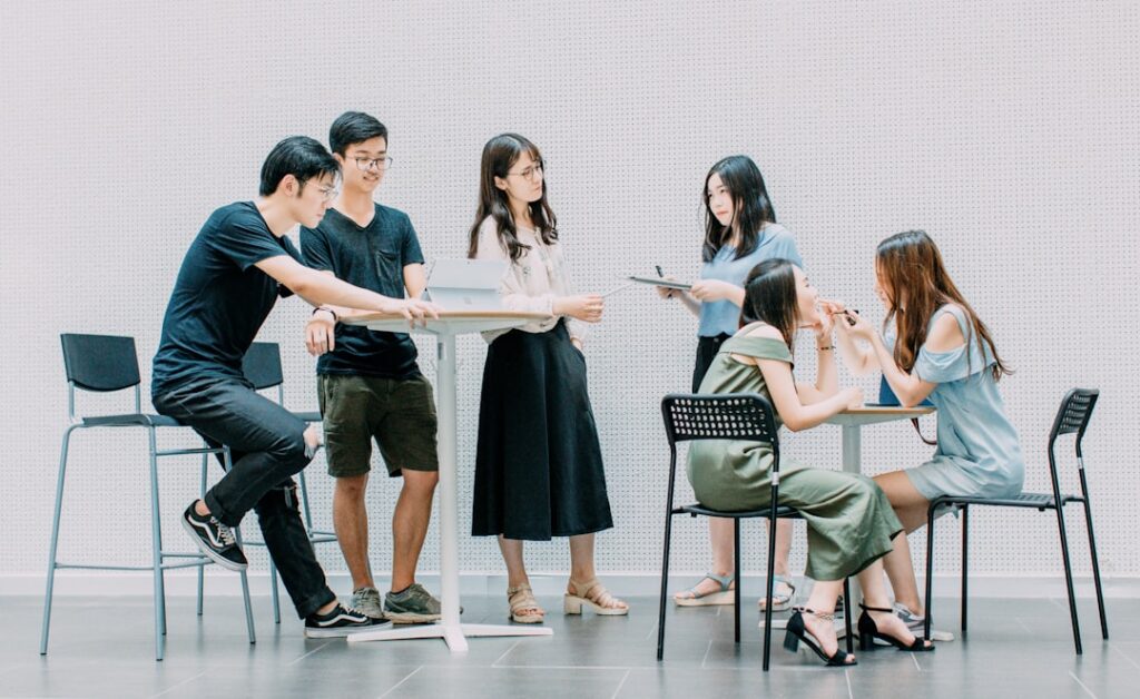 two men and four women meeting in office